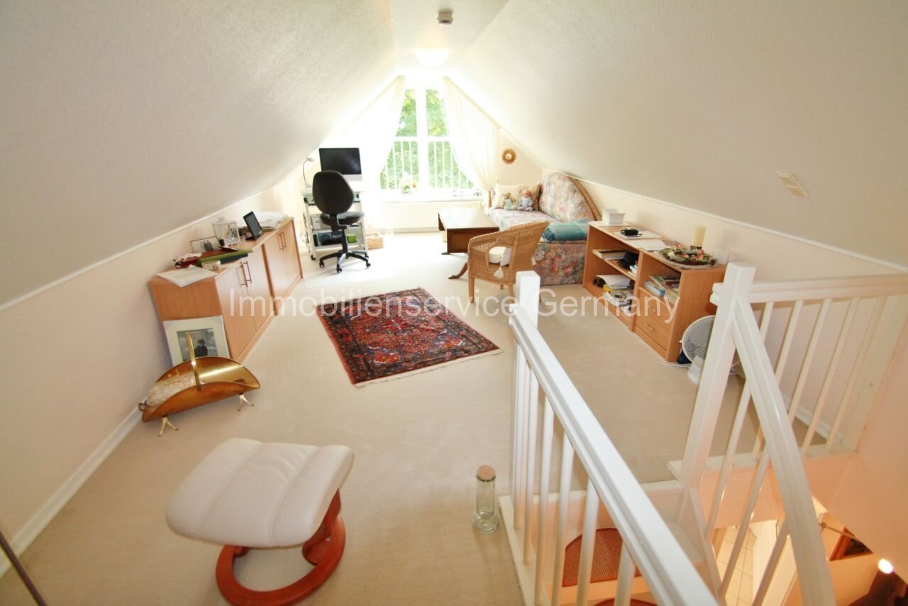 Bright attic office with intelligent room layout and integrated storage solution