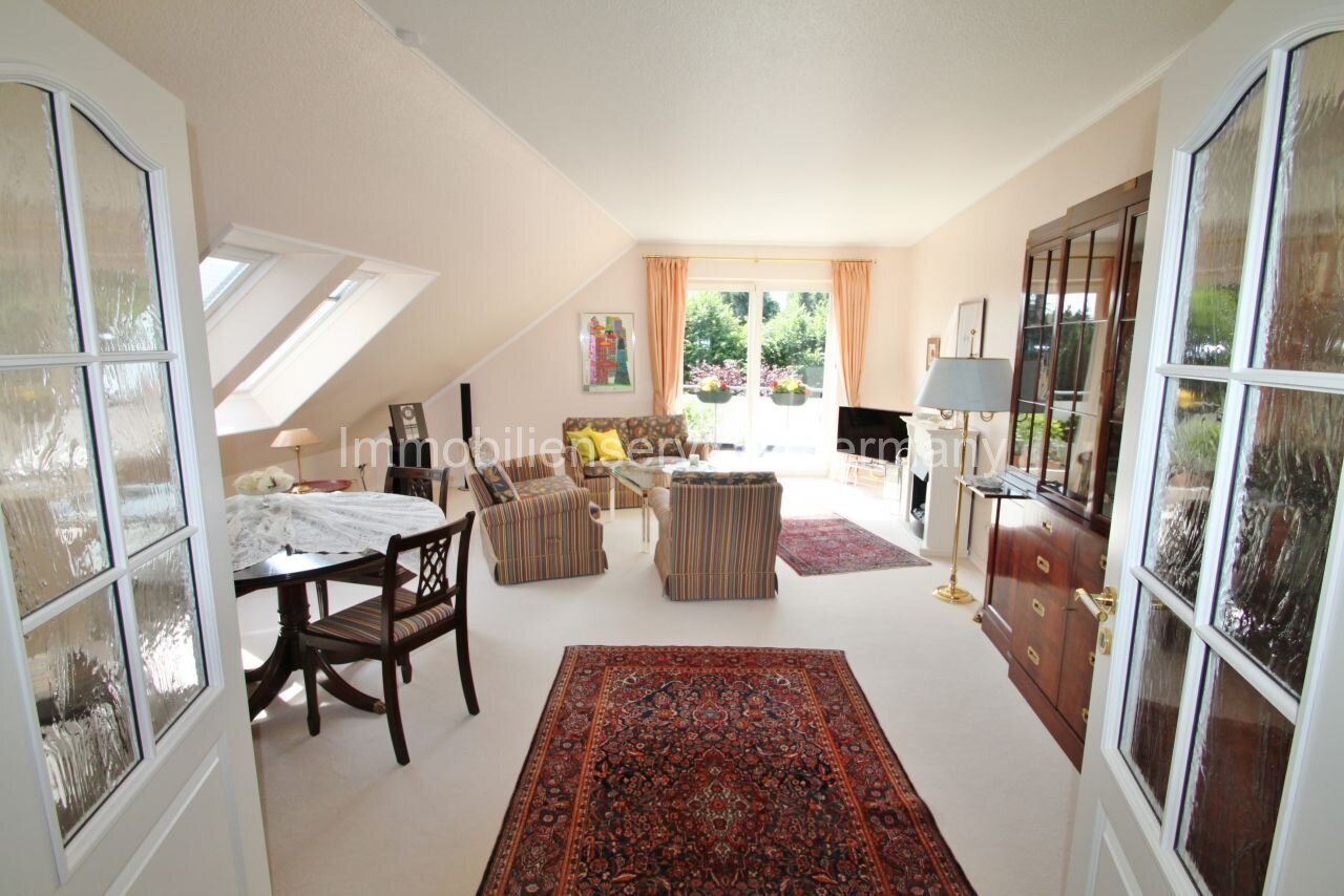 Attic apartment filled with natural light, with a breathtaking garden view and elegant double doors.